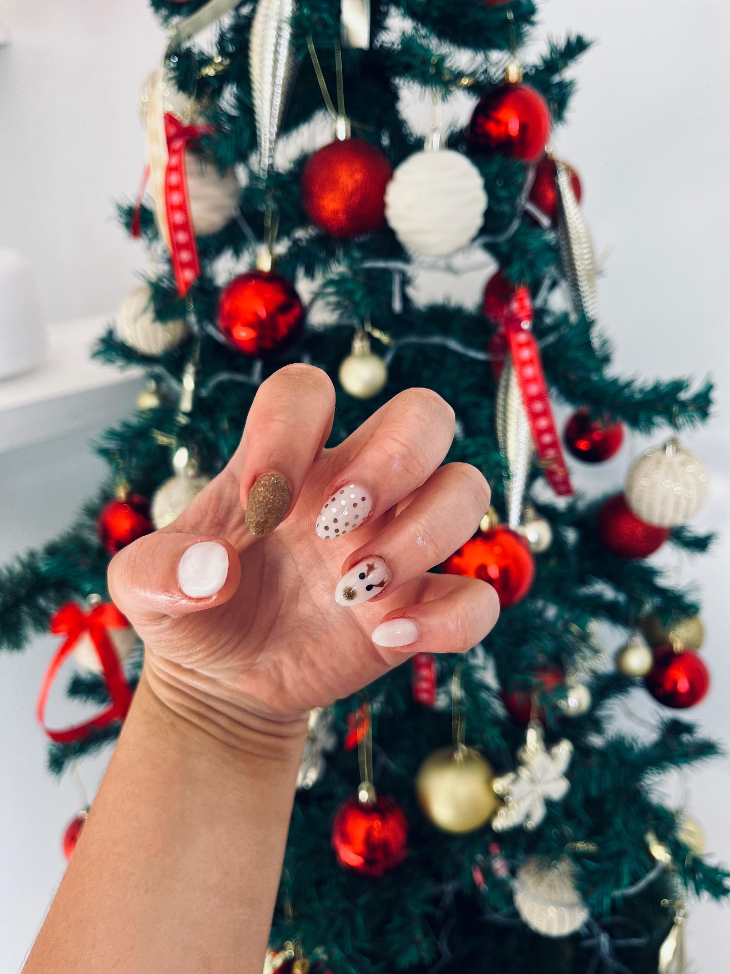 Festive Christmas nail art with snowman and glitter accents